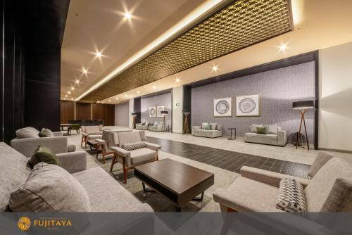 a lobby with couches and chairs and a table at FUJITAYA Querétaro in Querétaro