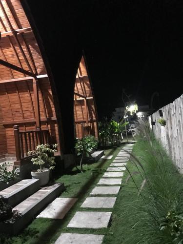 a walkway in front of a building at night at Volcano Valley in Kintamani
