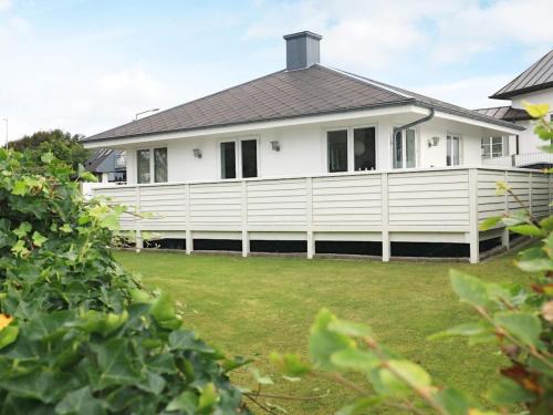 a white fence in front of a house at 2 person holiday home in Esbjerg V in Esbjerg