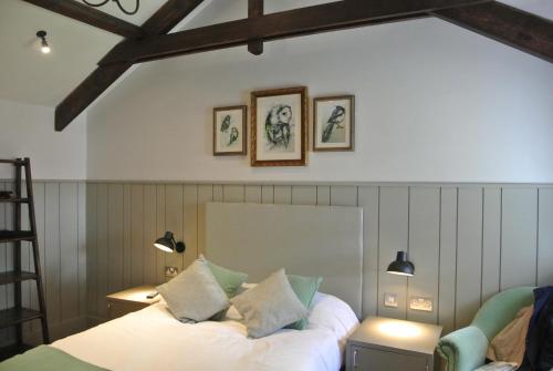 A bed or beds in a room at The Crown Pub, Dining & Rooms