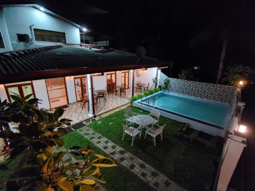 a backyard with a swimming pool at night at Andorra Tourist Resort Anuradhapura in Anuradhapura