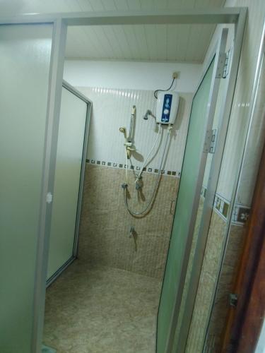 a shower in a bathroom with a phone on the wall at Andorra Tourist Resort Anuradhapura in Anuradhapura