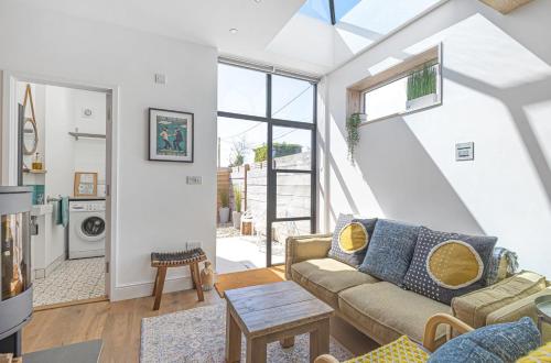 a living room with a couch and a table at Seagrass Cottage in Southwold, Stunning Property with Views! in Southwold