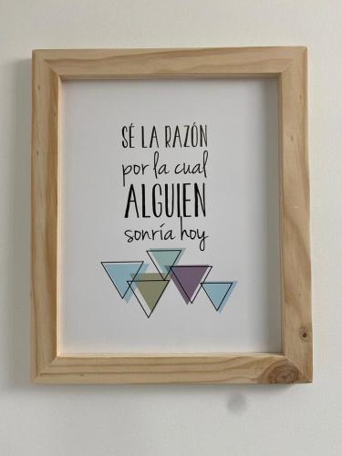 a framed picture with the words as la reunion pro ten card eighteen santa hog at Hotel Cafe Estrella in Armenia