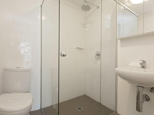 a white bathroom with a toilet and a sink at The Edge Apartment 5 Jindabyne in Jindabyne
