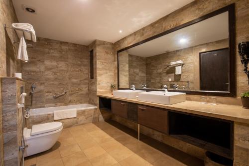 
a bathroom with a sink, toilet and bathtub at Hotel Tibet International in Kathmandu
