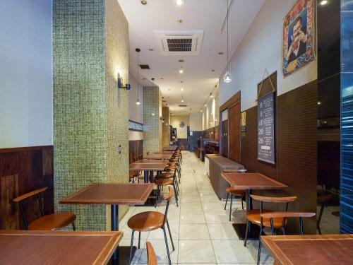 
a restaurant with tables and chairs in it at APA Villa Hotel Nagoya Marunouchi Ekimae in Nagoya

