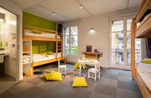 a room with bunk beds and a table in it at Ciarus in Strasbourg