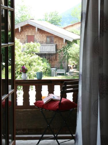 a chair with a book on it sitting on a balcony at Beim Heiß'n in Staudach-Egerndach