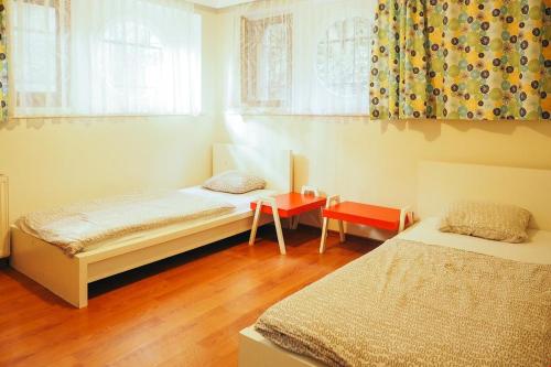 a bedroom with two beds and a table and window at Deeps Hostel Ankara in Ankara