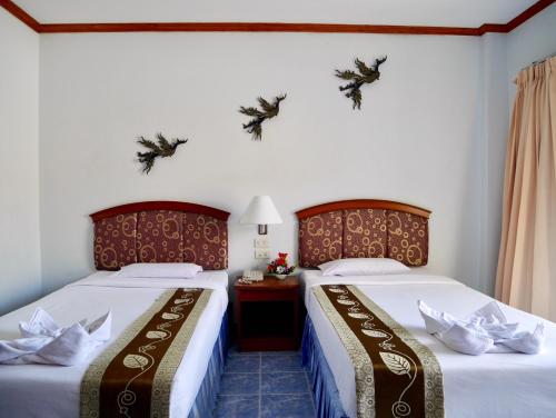 two beds sitting next to each other in a room at Krabi Golden Hill Hotel in Krabi town