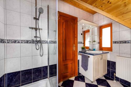 a bathroom with a shower and a sink and a tub at Holiday home Balatonbereny 18059 in Balatonberény