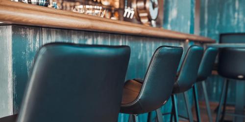 a row of chairs lined up against a wall at Ferienhauspark Asgard in Damp in Damp