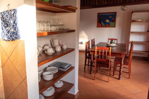 a kitchen and dining room with a table and chairs at Morrumbene Beach Resort in Morrumbene