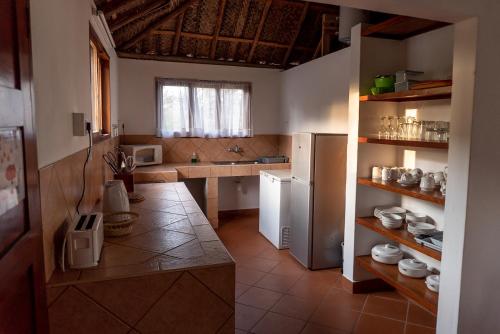 a kitchen with a refrigerator and a counter in it at Morrumbene Beach Resort in Morrumbene