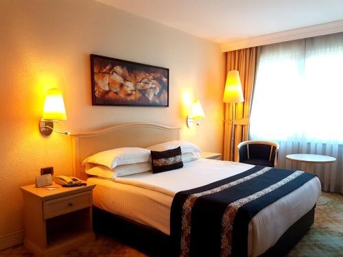 Säng eller sängar i ett rum på Jura Hotels Mavi Sürmeli Adana