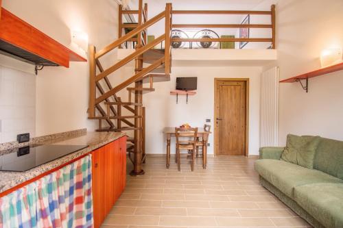 a living room with a couch and a staircase at Casa Vacanze Vecchio Granaio in Magione