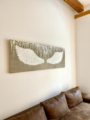 a couch in a living room with a picture on the wall at Angel Apartment Černý důl in Cerny Dul