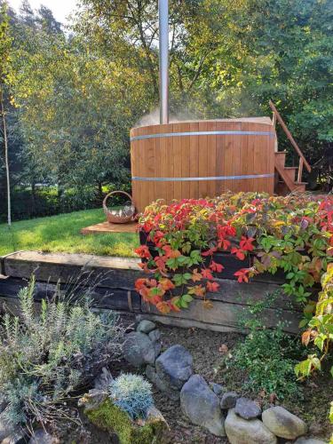a garden with red flowers in a wooden box at Forest Luxury Apartman in Dorogháza