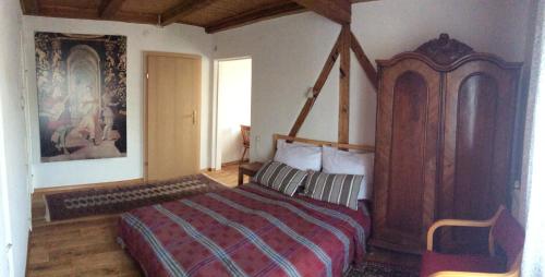 a bedroom with a large bed with a wooden canopy at Paulus Gästehaus Top3 in Salzburg