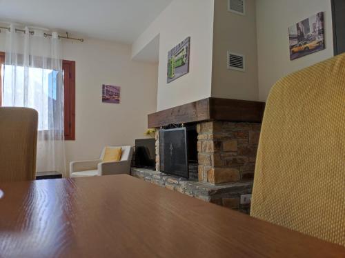 a conference room with a table and a fireplace at Los Altos de Escarrilla - tucasaenlospirineos in Escarrilla