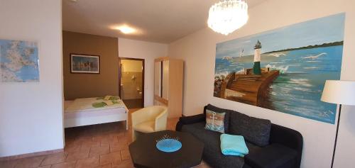 a living room with a couch and a bed at Pension Lenz in Sassnitz