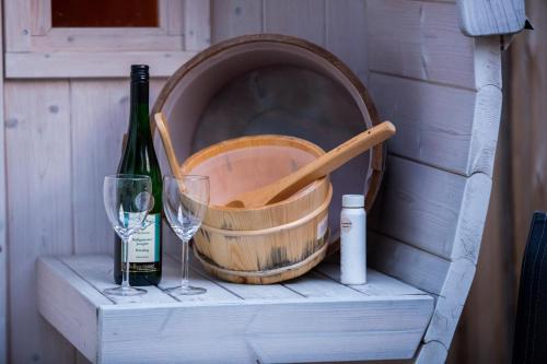 a wine barrel and a bottle and a wine glass at Pension Ferienhof Fischer in Freiberg