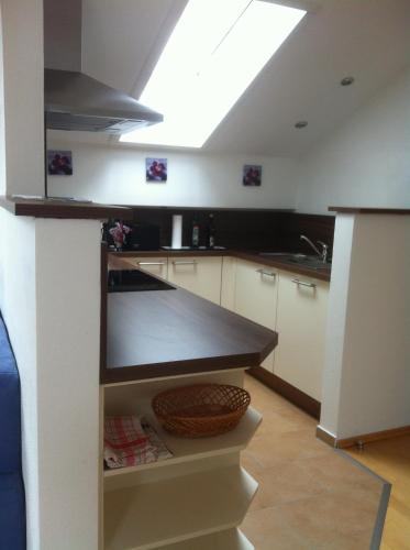a kitchen with a black counter top in a room at Ferienwohnung AmmerZonas & AmmerZone in Oberammergau