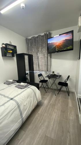 1 dormitorio con 1 cama y TV en la pared en bvapartments-Queensgate 2, en Huddersfield