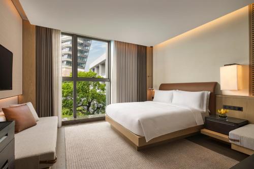 a bedroom with a bed and a large window at Intercontinental Shenzhen Dameisha Resort by IHG in Shenzhen