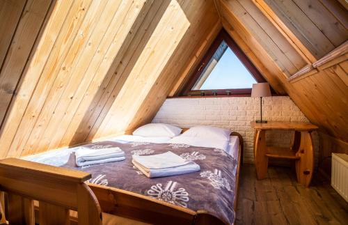 a bedroom with a bed in a attic at Apartamenty Tetmajera APARTZAKOP in Zakopane