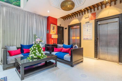 a living room with a blue couch and red pillows at Le Caspien Boutique Hotel in Marrakech