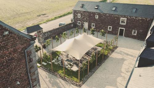 an overhead view of a building with a white umbrella at Domaine Sur Les Sarts in Ohey