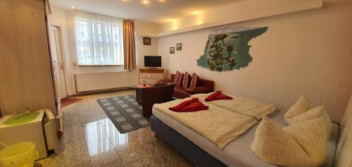 a bedroom with a bed and a living room at Pension Lenz in Sassnitz