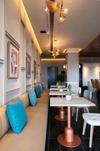 a row of tables and couches in a restaurant at Hotel LIVVO Lumm in Las Palmas de Gran Canaria