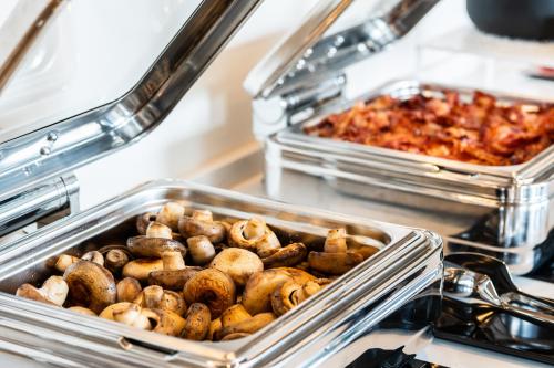 a bunch of food in trays in a buffet at Hotel LIVVO Lumm in Las Palmas de Gran Canaria