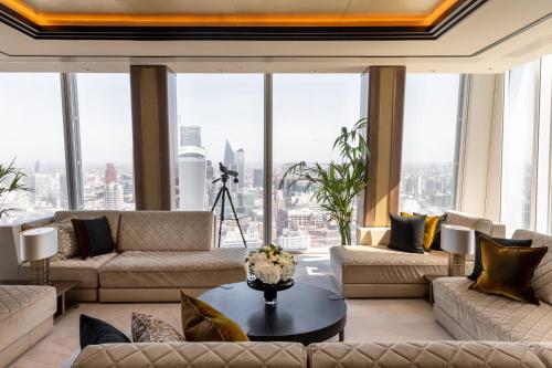 a large living room with couches and a table at Shangri-La The Shard, London in London