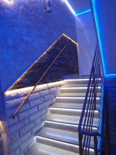 a set of stairs with a door and a blue light at Apartments and bungalows vila Dalibor in Nin