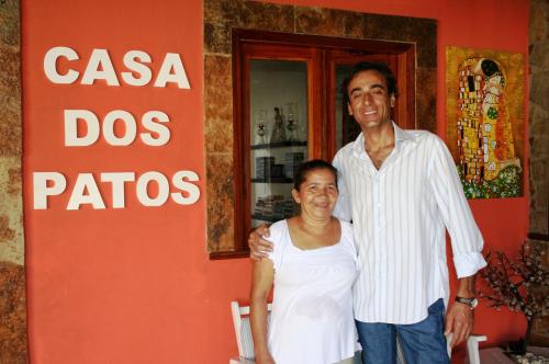 a man and a woman standing in front of a store at Casa Dos Patos in Flecheiras