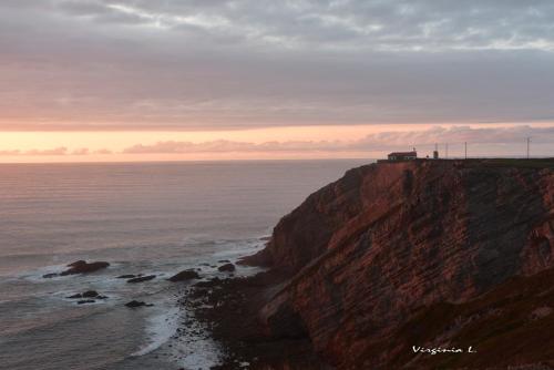 a view of the ocean from a cliff at Apartamentos rurales la Aguilera in Oviñana
