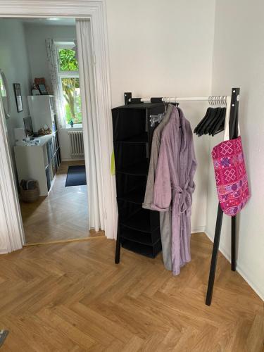 a room with a black dresser and a hallway at Spikergade 6 in Tønder