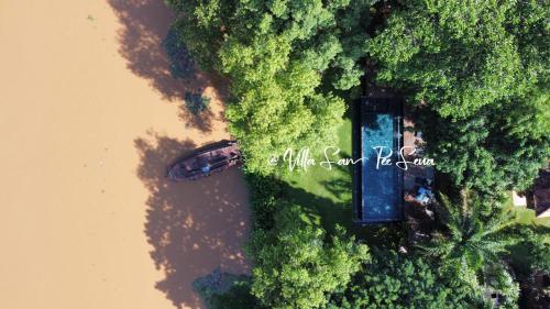 an overhead view of a body of water and trees at Villa San Pee Seua in Chiang Mai