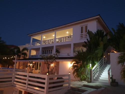 a large white house at night with lights at B2 APARTMENT with Balcony at JAN THIEL Curacao in Jan Thiel