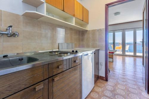 a kitchen with a sink and a counter top at Apartments Laura in Dramalj