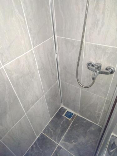 a shower with a shower head in a bathroom at Florya Park Hotel in Istanbul