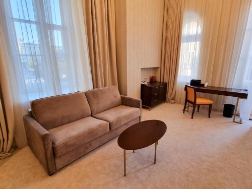 a living room with a couch and a table at Tiffi Old Town Hotel in Warsaw