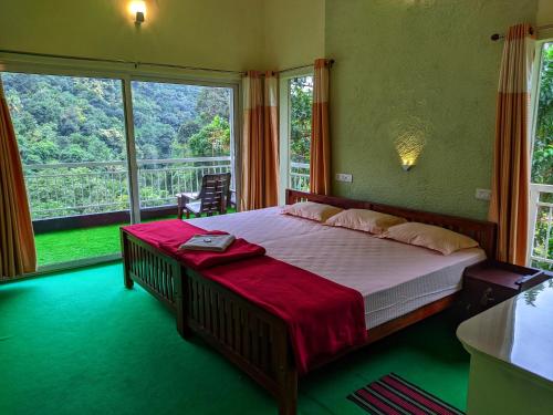 a bedroom with a large bed and a large window at Riverbench Homestay Munnar, Anaviratty in Anaviratty