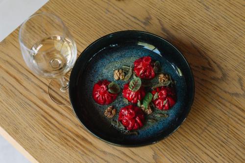 a black bowl of food next to a wine glass at Vazisubani Estate in Vazisubani