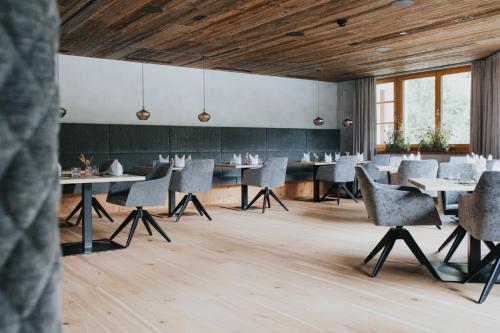 a dining room with tables and chairs at Hotel Tauernhof in Grossarl