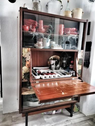 a cabinet full of dishes and pots and pans at Casa borghetto in Cancellara